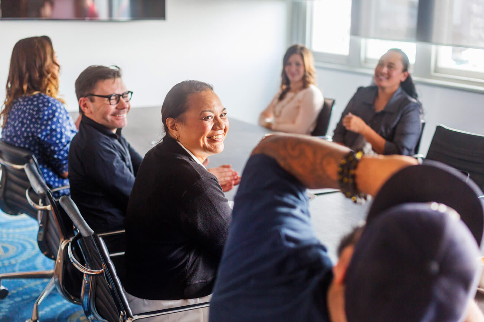 A group of coworkers sitting around a meeting table